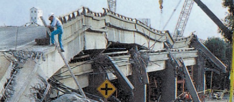 archival photograph of San Francisco-Oakland Earthquake bridge collapse and worker